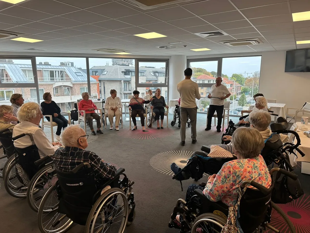 Seniors participating in group fitness activity in bright room with instructors